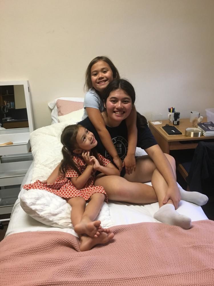 Kelly Brannan '19 and her two sisters, Sadie and Audrey, in her room on move-in day. 