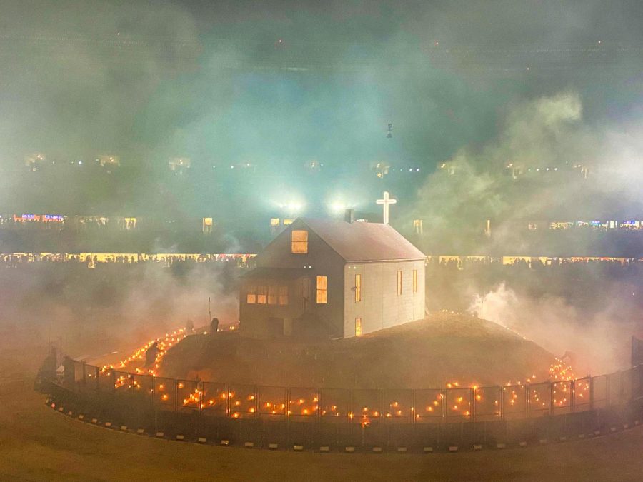 Candles burn around Kanye West’s recreation of his childhood home in Soldier Field, Chicago.