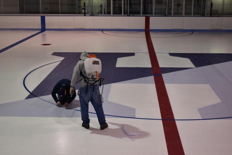 Facilities management team sets the rink up for the 2021 ice hockey season. Photo by Jesse Corser-James 23