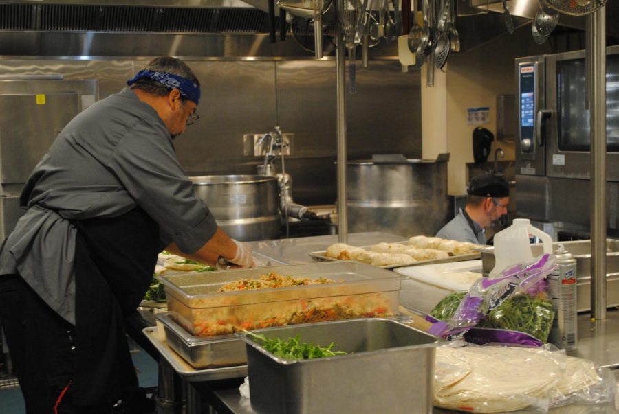 Executive Chef Mark Henkle (right) and Chef Steve Taylor Sous prepare pesto chicken wraps for lunch. 