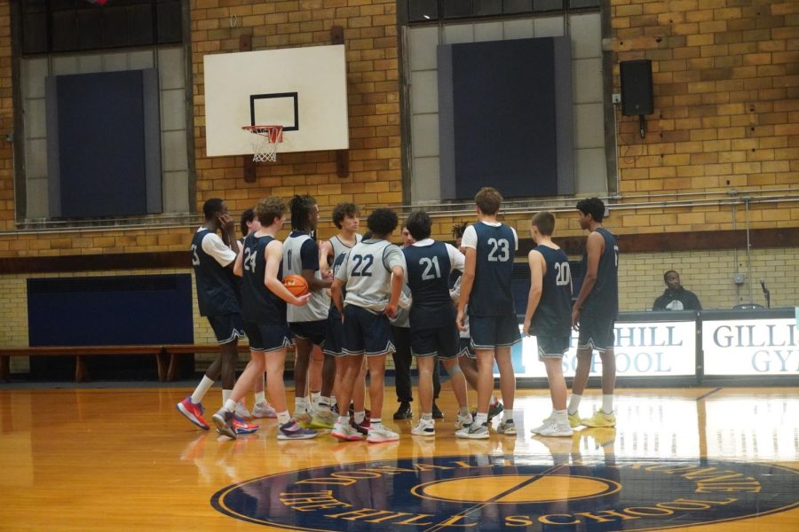 The varsity boys basketball team huddles at the end of every practice, joining together once more before they end the day.