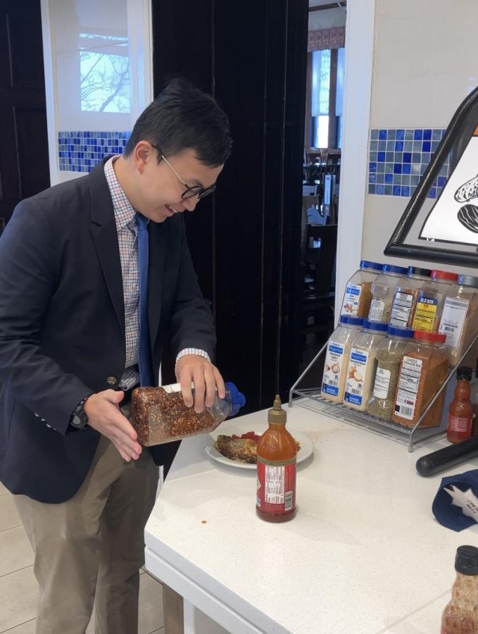 Andre Lo 24 dresses up his meal with red pepper flakes. The new spice rack was one of the many additions Sodexo made to the dining hall over spring break.