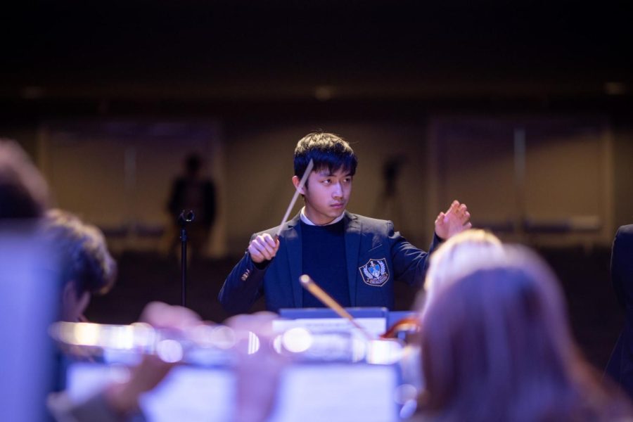 Casey Li takes on role of conductor during the winter orchestra concert.