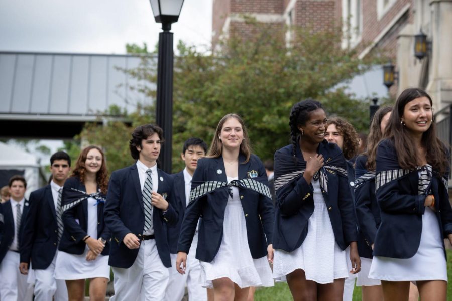 Students walk during the 2022 commencement. The way scarves are worn by female-identifying students has come under criticism in recent years.
