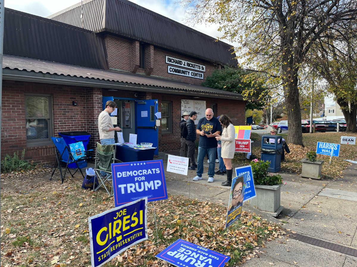 Poll workers gather outside of the Ricketts Center, a local polling location in Pottstown, Pa. 