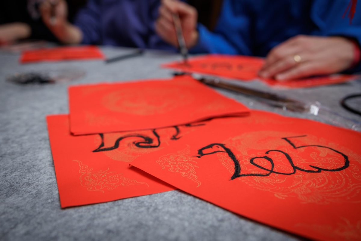 Students practice calligraphy as part of the Lunar New Year. Calligraphy was one of the many interactive activities added to the annual celebrations in the hope to engage more community members. 