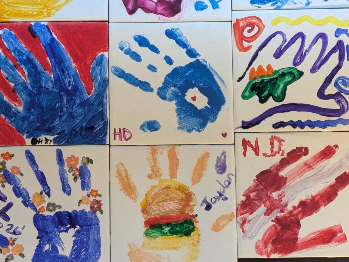 Students decorated tiles during "A Thousand and One Hands," a community art project held on Martin Luther King Jr. Day. The project was one of four art programs designed for students to reflect on their identity and impact in light of MLK's legacy.