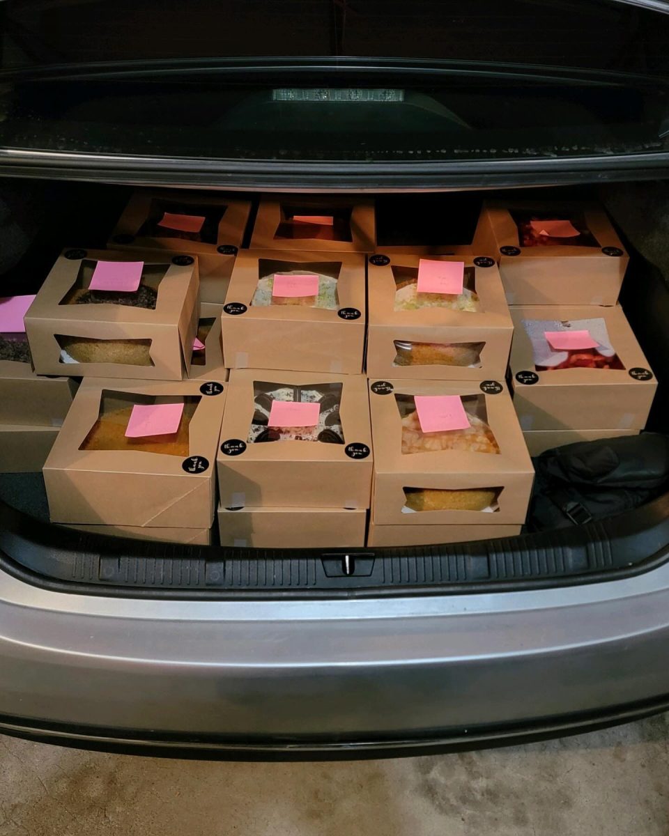 Jaelen Toole '25 loads the back of his car to fulfill cheesecake orders, the major product of his home baking business. Toole's experience as a day student, with its more flexible expectations and schedules, helped his business thrive. 