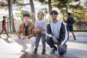 Yancy Sun '26 and Abhi Siripurapu '25 playing basketball with younger members of the Pottstown community during community service. 
