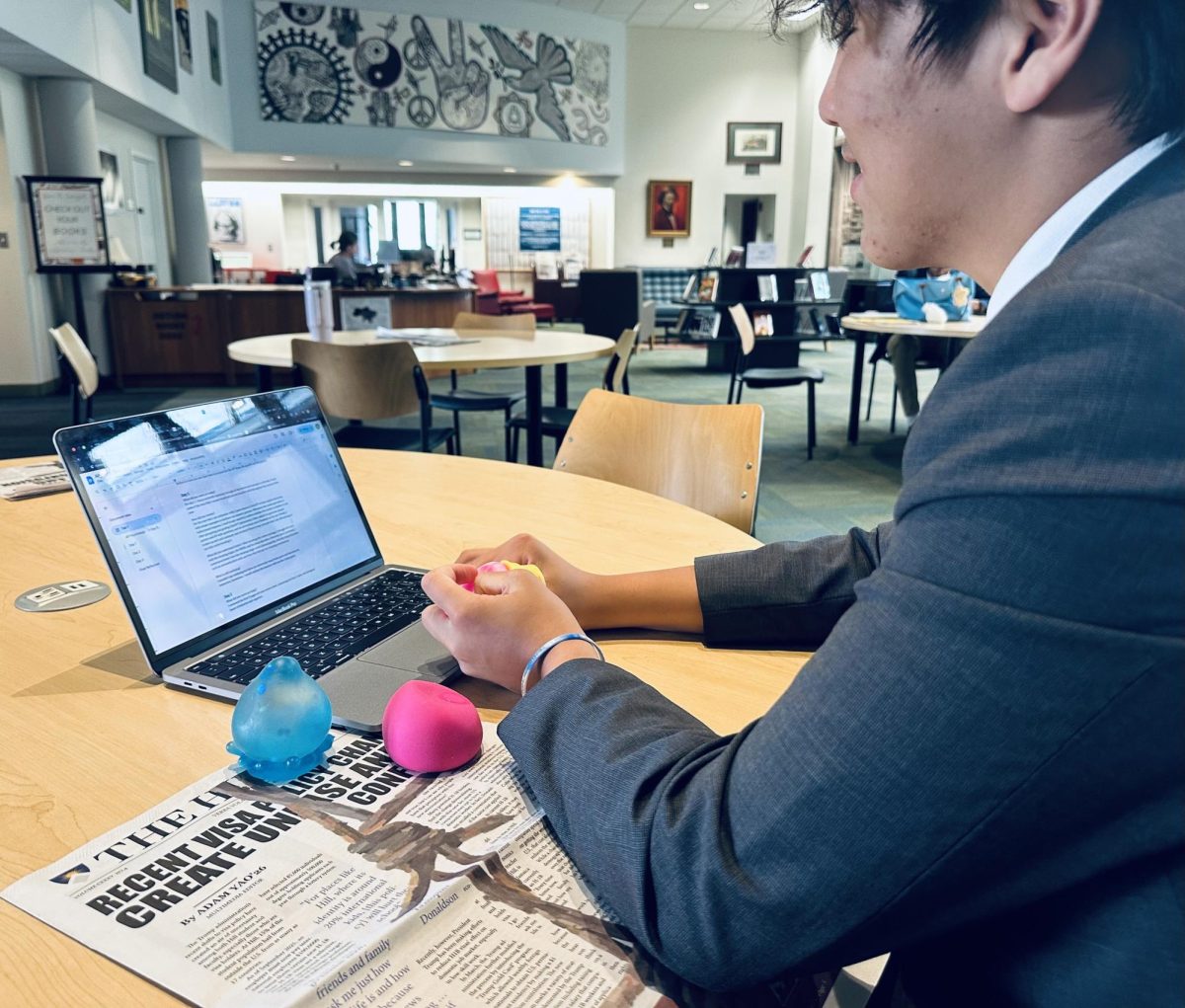 Ray Chiang '29 plays with his NeeDoh collection in the Ryan Library. Though Chiang has owed his toys for several years, he noticed these squishy playthings become more popular over the past few months. 